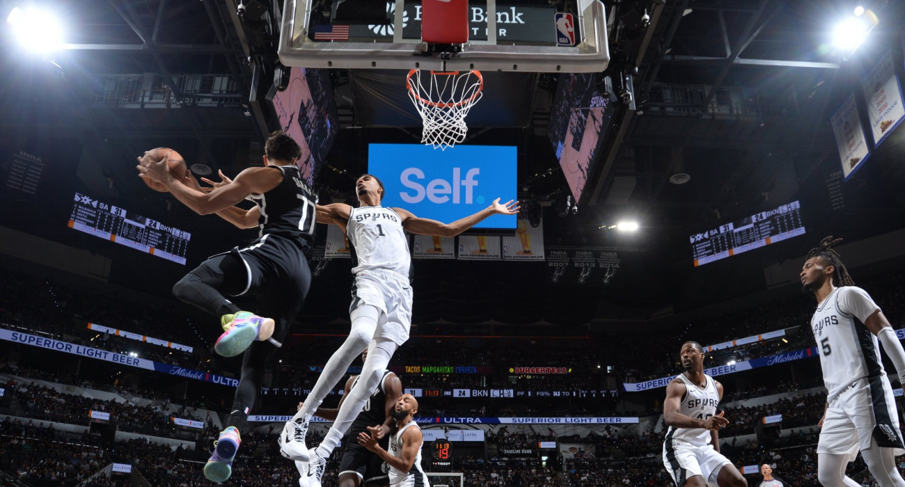 Ο Βίκτορ Γουεμπανιαμά προσπαθεί να μπλοκάρει τον Μπεν Σαράφ/Photos by Michael Gonzales/NBAE via Getty Images